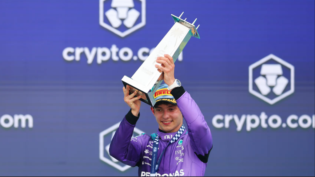 Kimi Antonelli celebrates on the Miami GP podium holding the winner’s trophy after his 2026 Formula 1 victory.